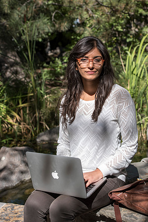 Student Noor Sofi poses in the Gardens for online learning.