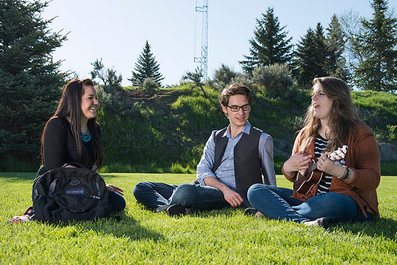 Student models interact and smile for marketing purposes that will be used for the new Campus Housing next to The Ivy.