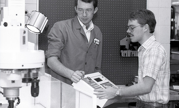 Student works alongside teacher in Manufacturing Technology. December 1990.