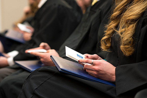 Students of the College of Human Development receive their diploma cover.