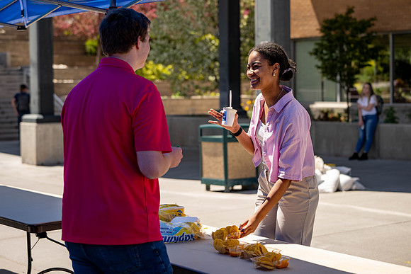 Spirit Fest Booths on campus, students talking and having fun together.