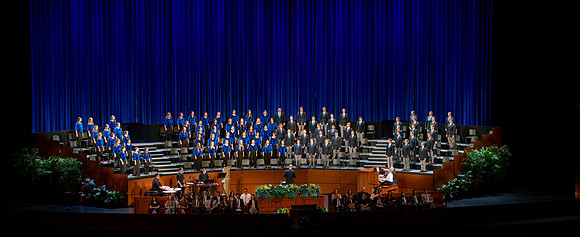Women and men choir performing during devotional.
