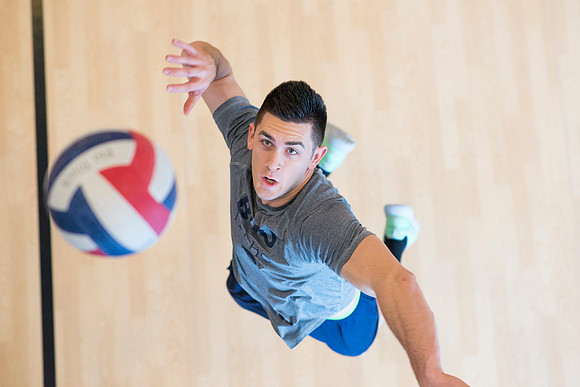 Cameron Olsen spikes the ball during his volleyball class in the I-Center.