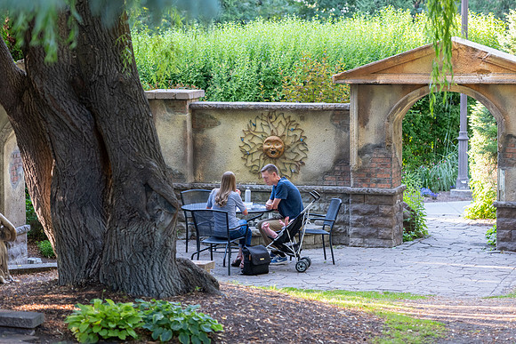 Father, Mother, and child at a table in the Ricks Gardens