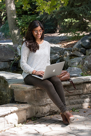 Student Noor Sofi poses in the Gardens for online learning.