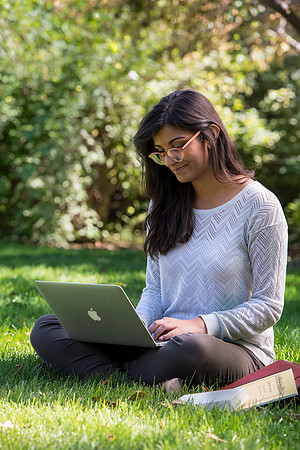 Student Noor Sofi poses in the Gardens for online learning.