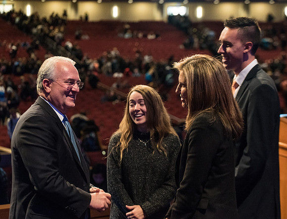 Elder Gerard talking with students after devotional.