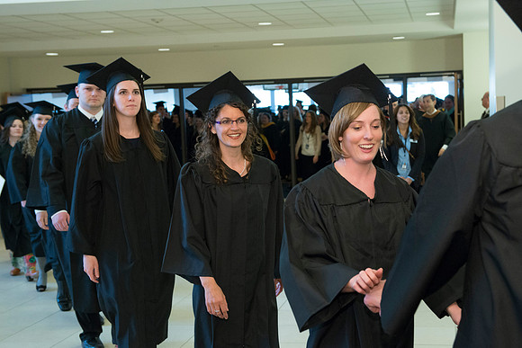 Graduates gather and march in during the processional for April 2014 Graduation ceremonies in the BYU-Idaho Center.