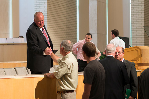 Devotional Speaker Garth Nelson is warmly greeted after his devotional talk.