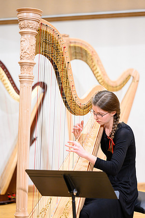 The harp ensemble performs in the recital hall in the Snow building.