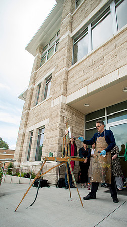 Brother Bodily gives a painting demonstration during his Oil Painting class outside the Spori Building.