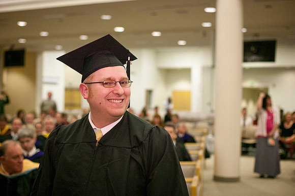 A graduate gets ready to receive his disploma in the Taylor Chapel.