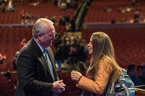 Elder Gerard talking with students after devotional.
