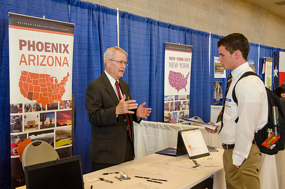 BYU-Idaho students speak to representatives from colleges or companies from their field of study at a career fair held in the I-Center gym