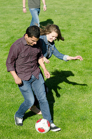 A group of students play a friendly game of soccer.