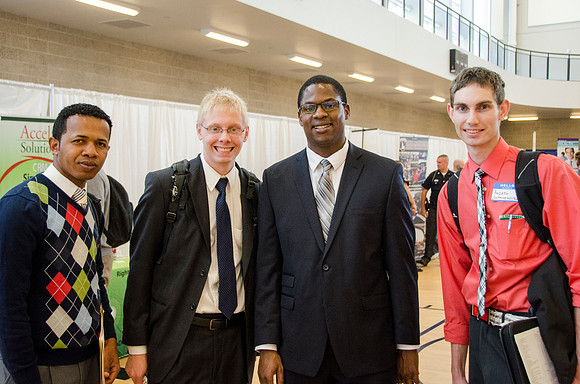 BYU-Idaho students pose for the camera at a career fair held in the BYU-I Center Gym