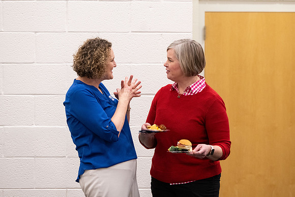 Employees gather for the annual Christmas gathering with President and Sister Meredith.