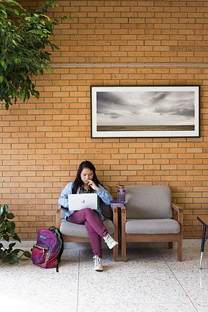 Students prepare for their classes, in the McKay Library.