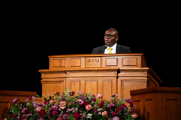 Elder Egbo speaking to students in the BYUI Center.