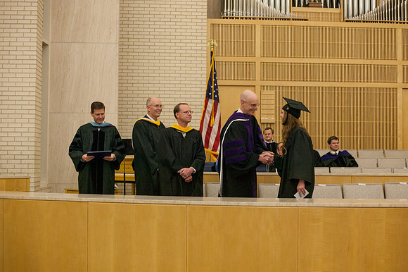 Advancement Vice President Henry J. Eyring congratulates students in the Taylor Chapel.