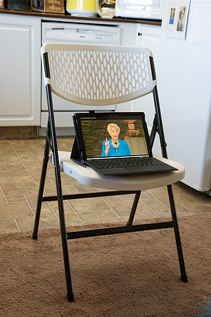 A couple watching Elder and Sister Renlund's live broadcast devotional to BYU-Idaho from Salt Lake City because of travel restrictions during Covid-19 pandemic.