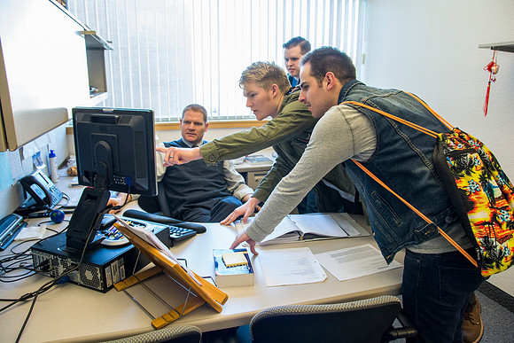 Jeremy Lamoreaux, faculty member of the Brigham Young University-Idaho Political Science department, with students in his office.
