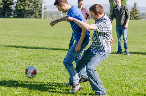 A group of students play a friendly game of soccer.
