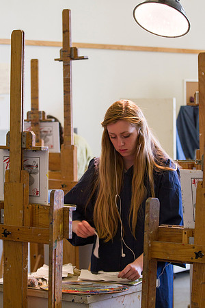 A student in Brother Bodily's Painting class prepares her canvas to paint on.