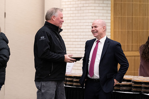 Employees gather for the annual Christmas gathering with President and Sister Meredith.