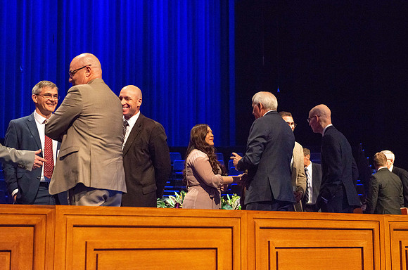 Brother Jan E. Newman greeting a student after devotional.