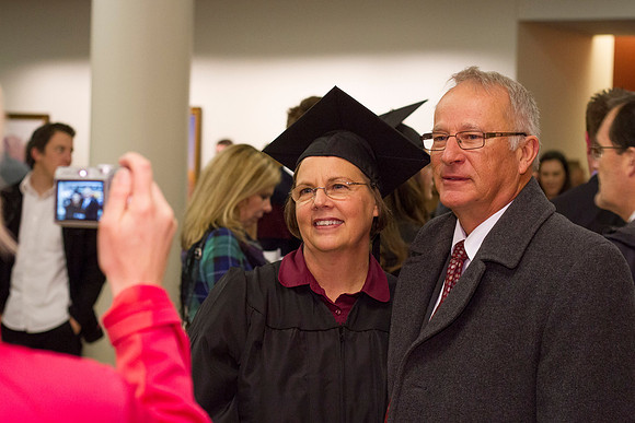A graduate poses with her husband after Commencement.