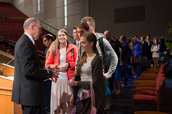 Russel T. Osguthorpe, the president of the the General sunday School, greets students and employees after devotional.