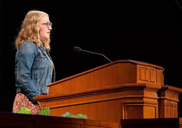 Student sharing a scripture during devotional.