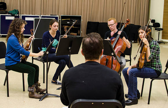 A member of the Shanghai String Quartet working with student ensembles.