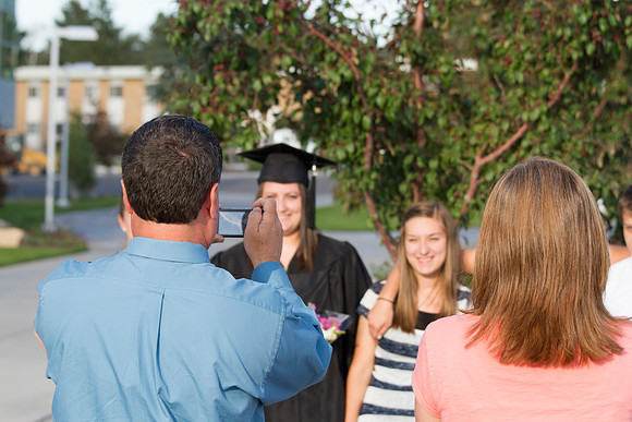 Graduates meet outside on the BYU-Idaho campus after commencement to take pictures before convocation starts.