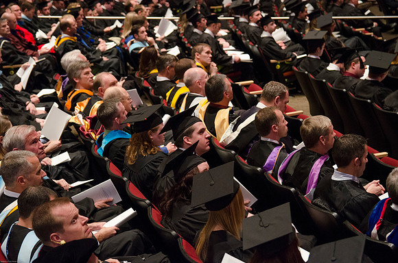 Faculty and Students sit at Graduation Commencement Ceremony.