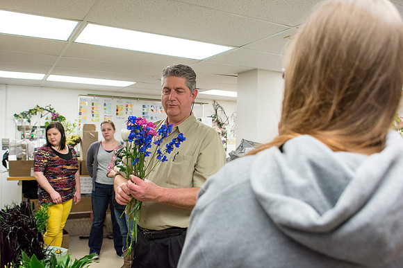 Horticulture students prepare for a semester review fashion show that will show their floral designs as well. Brother Romney leads the students along with other instructors.