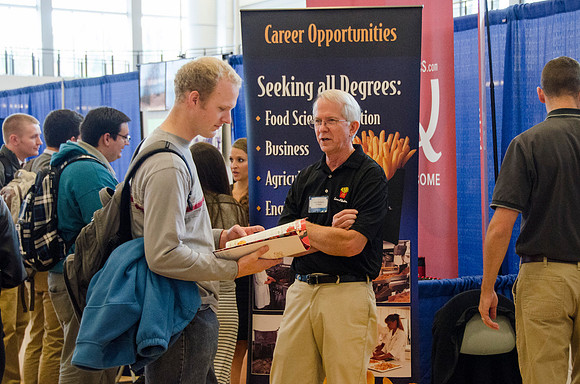 BYU-Idaho students speak to representatives from colleges or companies from their field of study at a career fair held in the I-Center gym