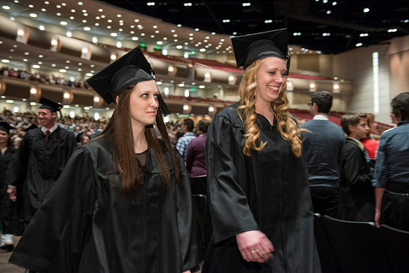 Graduates gather and march in during the processional for April 2014 Graduation ceremonies in the BYU-Idaho Center.
