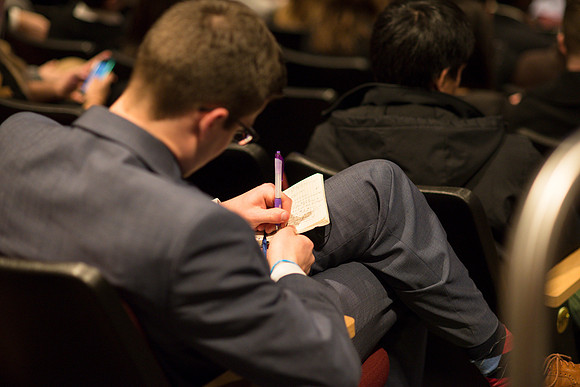 Students listen and take notes to Randal L. Ridd during the World Wide Devotional