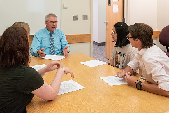 Instructor Brent Bean teaching Communication class.
