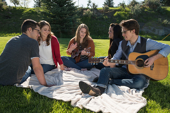 Student models interact and smile for marketing purposes that will be used for the new Campus Housing next to The Ivy.