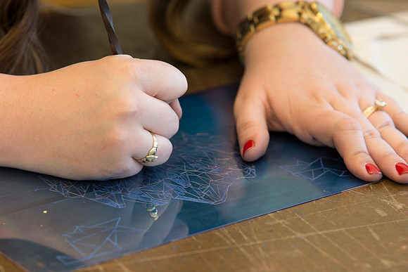 A student in Sister Jimison's Printmaking class works on an assignment during class in the Spori Building.