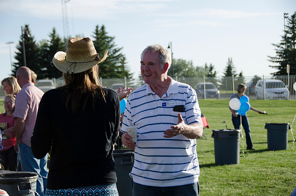 Online instructors gather with their families for an eveing of BBQ and games.