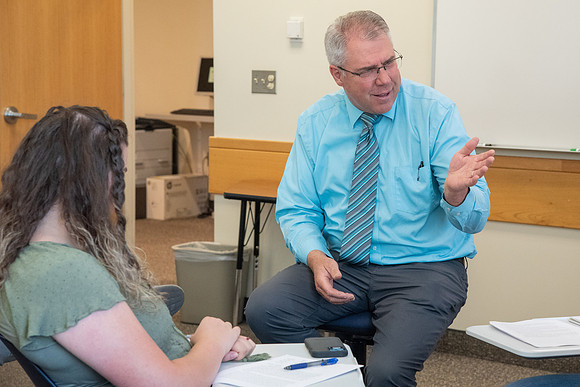 Instructor Brent Bean teaching Communication class.