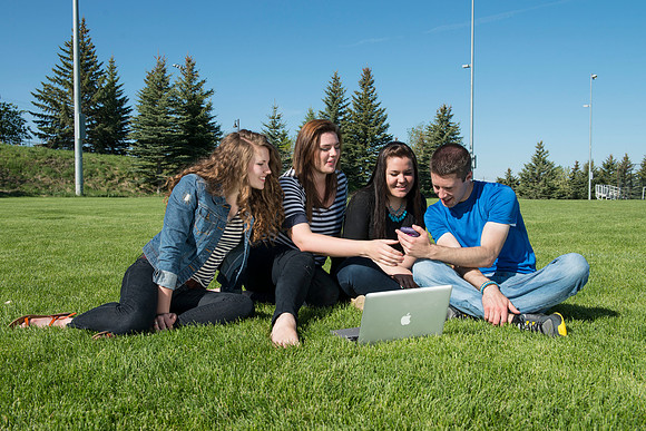 Student models interact and smile for marketing purposes that will be used for the new Campus Housing next to The Ivy.