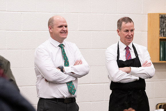 Employees gather for the annual Christmas gathering with President and Sister Meredith.
