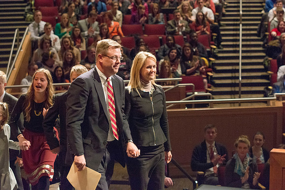 Brigham Young University-Idaho's newest President of the University, Clark Gilbert, walks up to the podium with his family. Photo by Ryan Chase