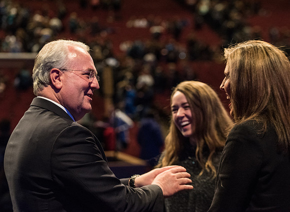 Elder Gerard talking with students after devotional.