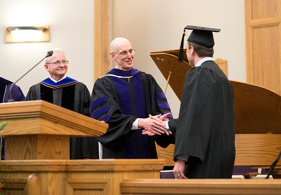 Students of the College of Human Development receive their diploma cover.